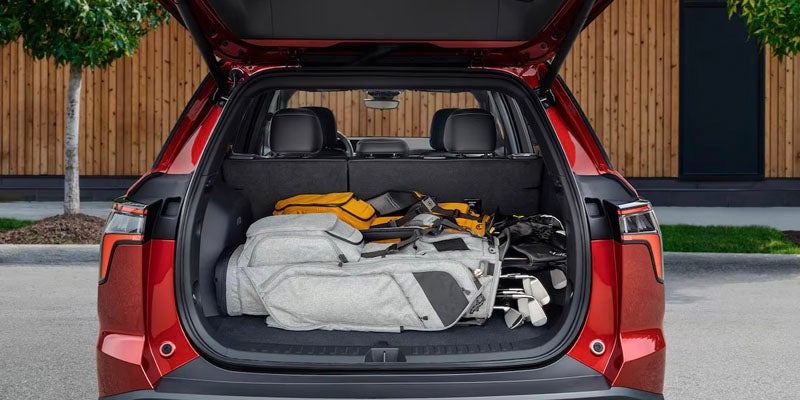 2025 Chevrolet Equinox trunk with golf clubs and a backpack
